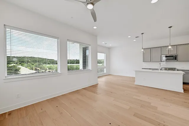 a view of a kitchen with a sink and a refrigerator