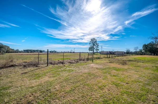 a view of a field with an trees