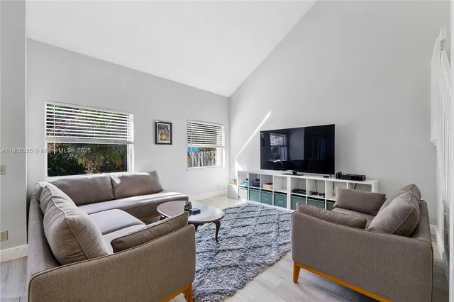 a kitchen with stainless steel appliances kitchen island granite countertop a refrigerator and a sink