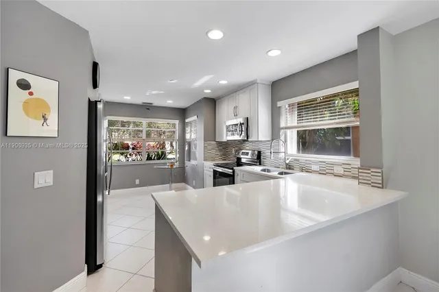 a bathroom with a sink and mirror with toilet