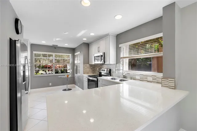 a bathroom with a toilet sink vanity and mirror