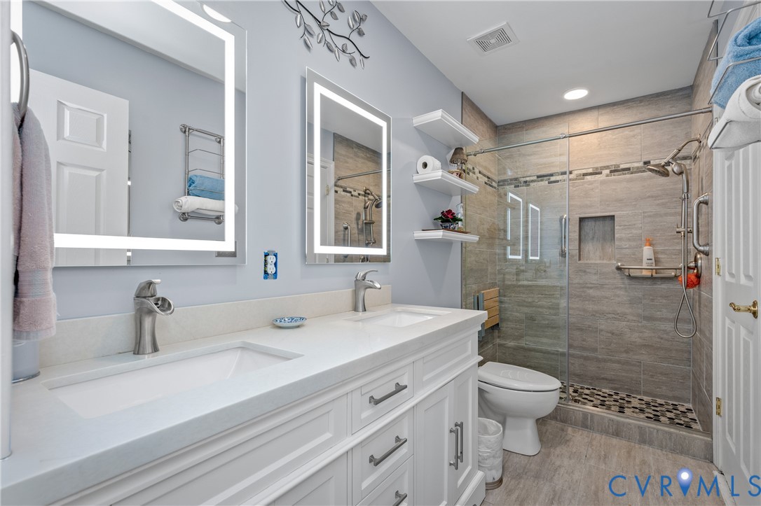 2205 Magnolia Grove Way Midlothian, VA 23113 - Photo 32 of 37 a bathroom with a sink toilet and shower