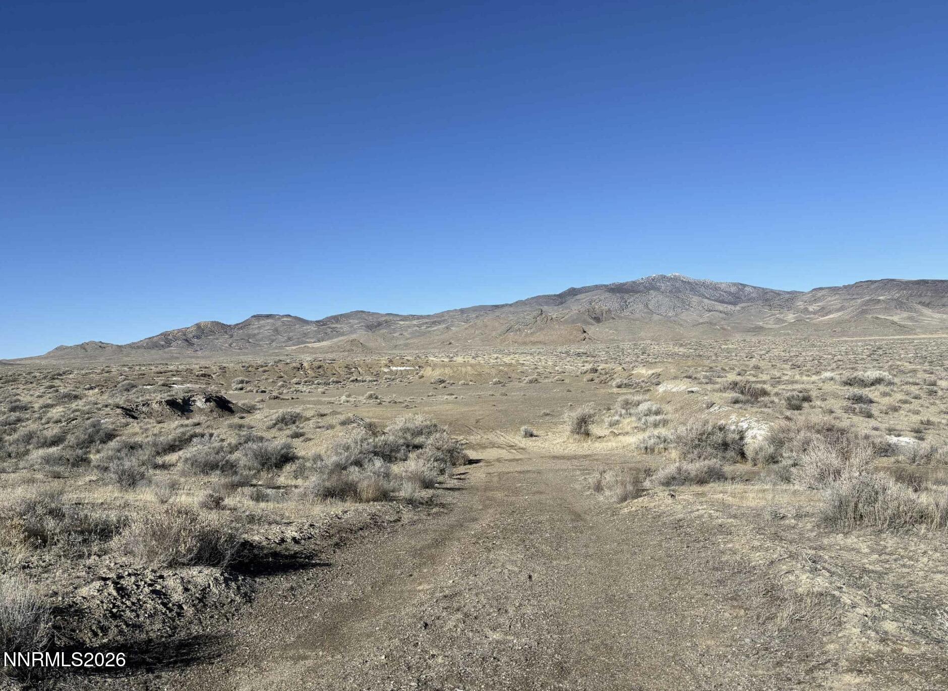 101213 Fencemaker Road Lovelock, NV 89419 - Photo 15 of 17 a view of a large mountain with mountains in the background