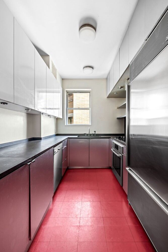 27 East 95th Street, Unit 3E Manhattan, NY 10128 - Photo 3 of 15 a kitchen with stainless steel appliances cabinets a sink and a counter top space