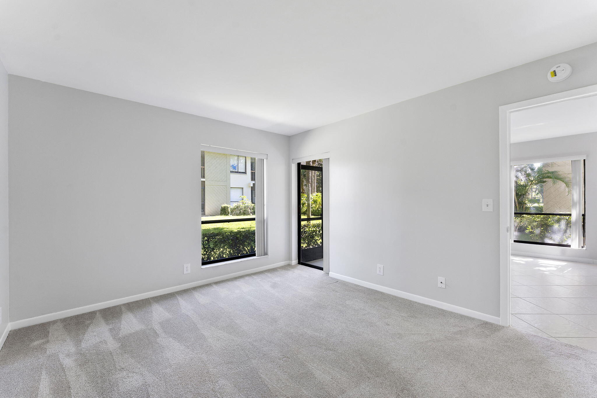 159 Northwest 70th Street, Unit 603 Boca Raton, FL 33487 - Photo 16 of 35 a view of a livingroom with wooden floor and a window