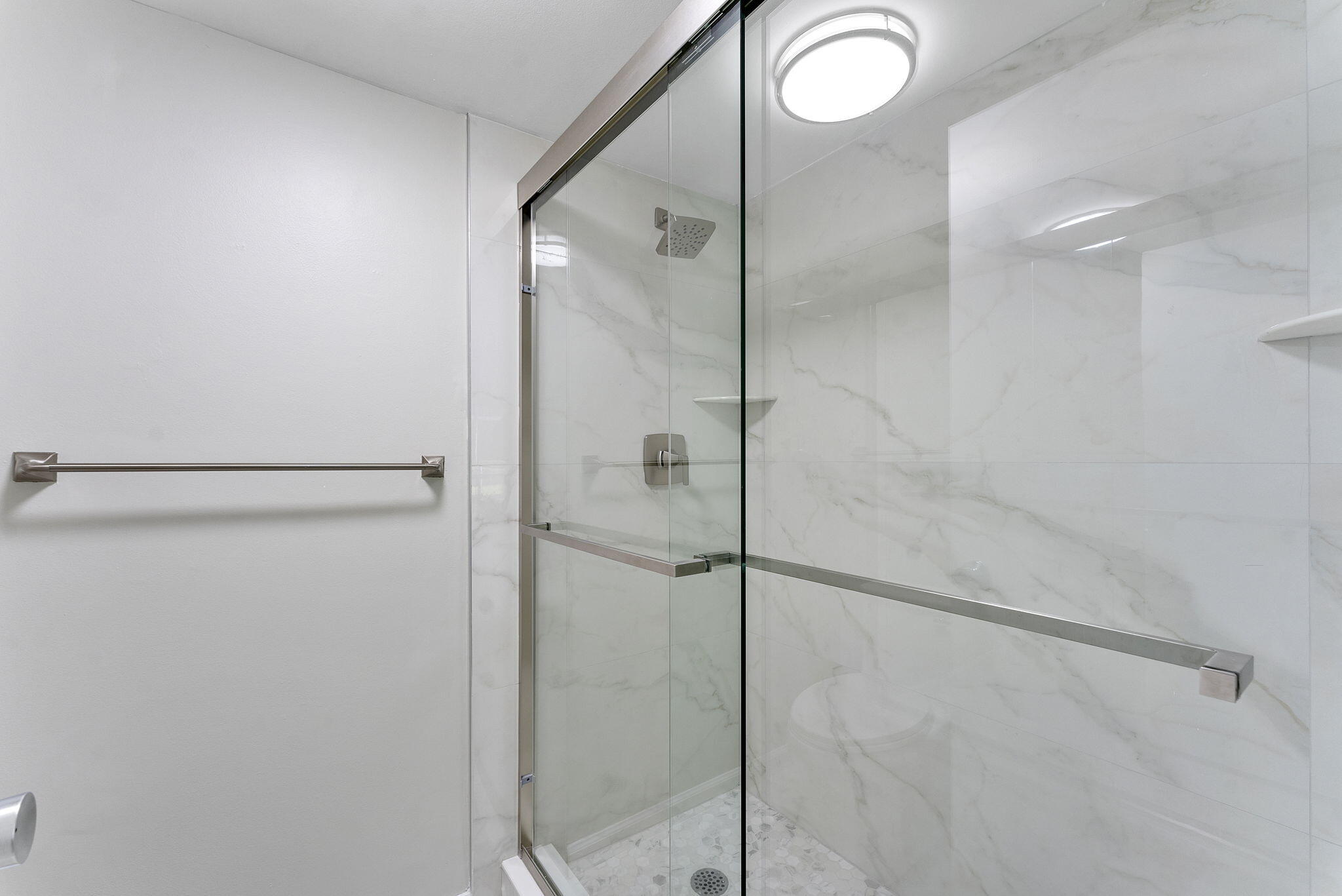 159 Northwest 70th Street, Unit 603 Boca Raton, FL 33487 - Photo 18 of 35 a bathroom with a glass shower door and a sink