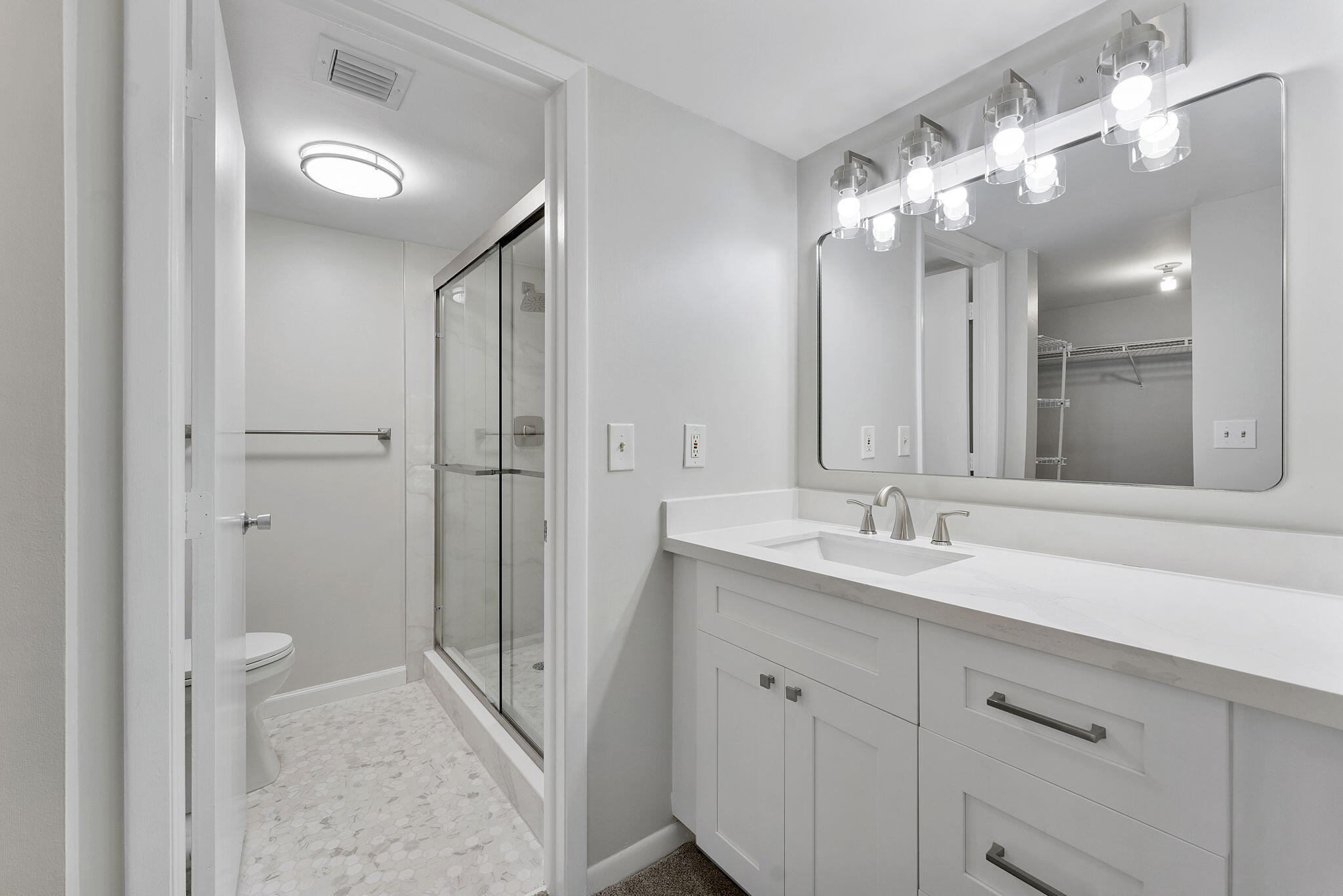 159 Northwest 70th Street, Unit 603 Boca Raton, FL 33487 - Photo 19 of 35 a bathroom with a double vanity sink mirror and shower