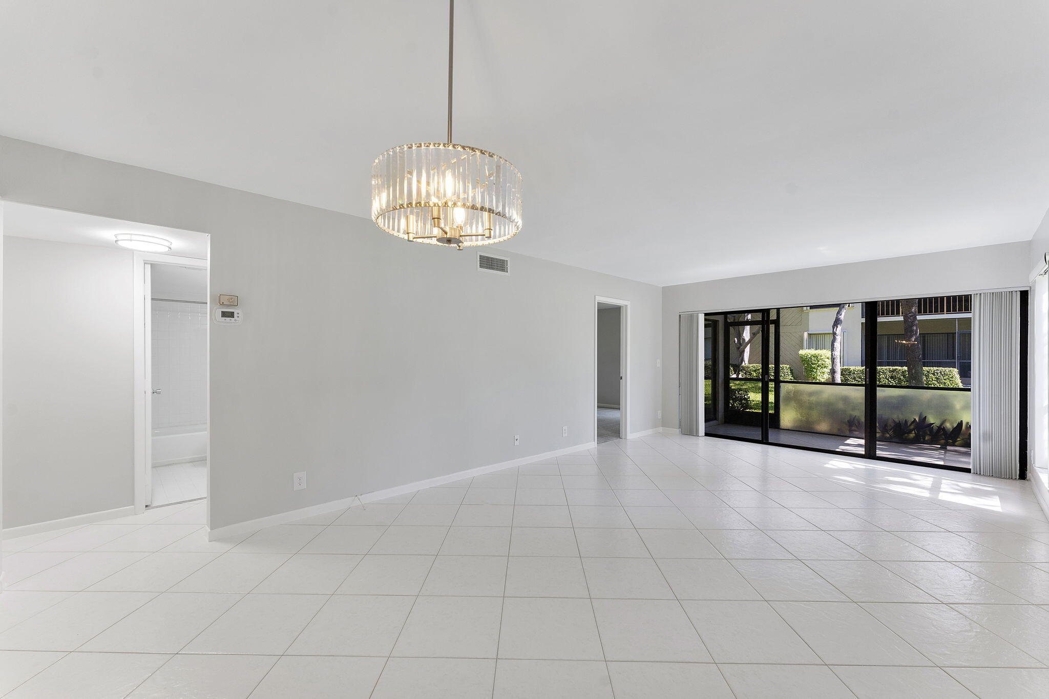 159 Northwest 70th Street, Unit 603 Boca Raton, FL 33487 - Photo 21 of 35 a view of an empty room with a chandelier