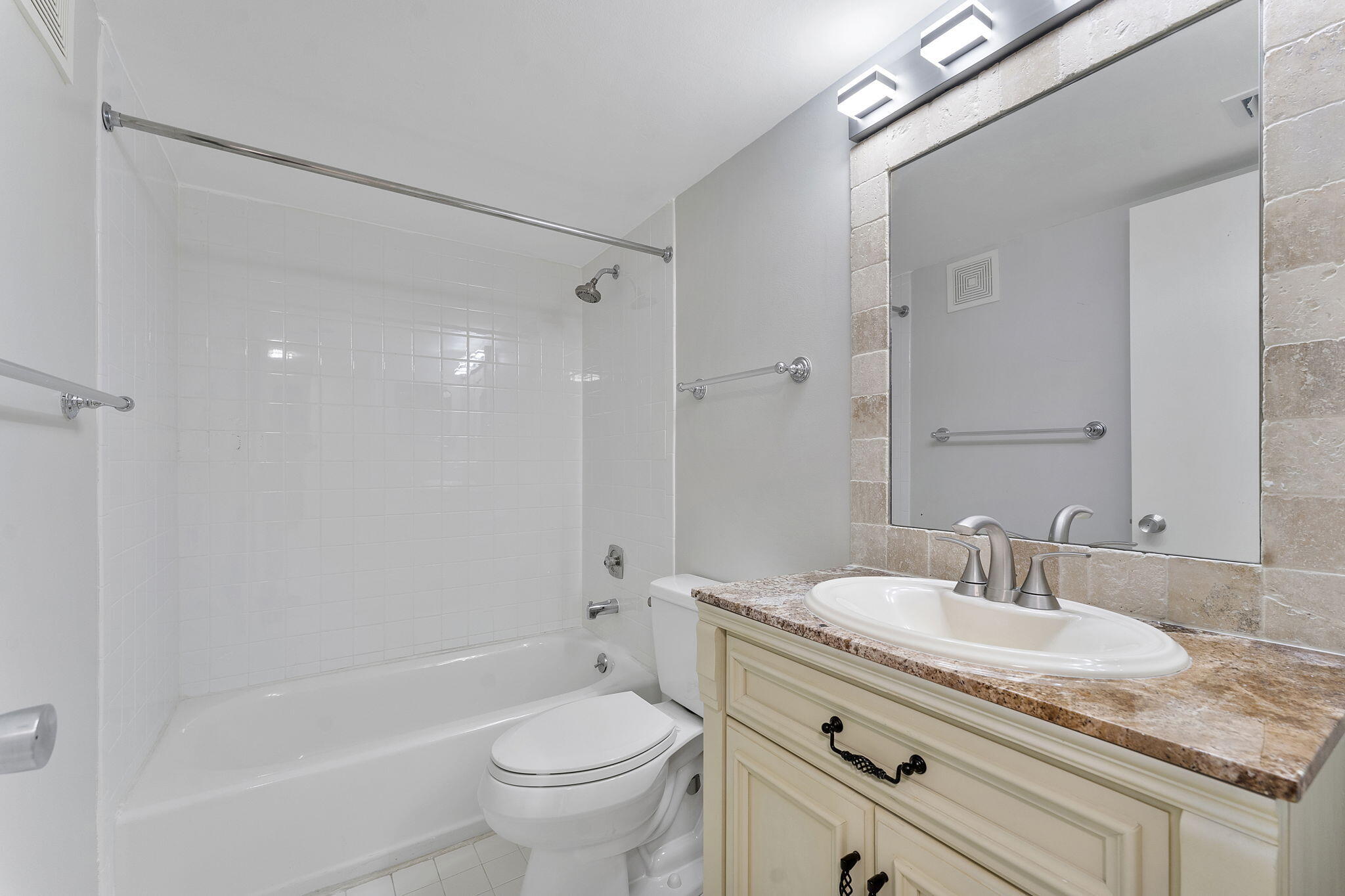 159 Northwest 70th Street, Unit 603 Boca Raton, FL 33487 - Photo 24 of 35 a bathroom with a granite countertop sink a toilet and shower