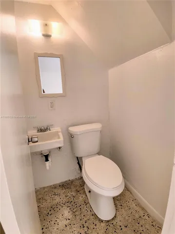 a white toilet sitting next to a bathroom sink
