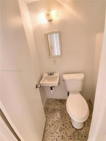 a white toilet sitting next to a bathroom sink