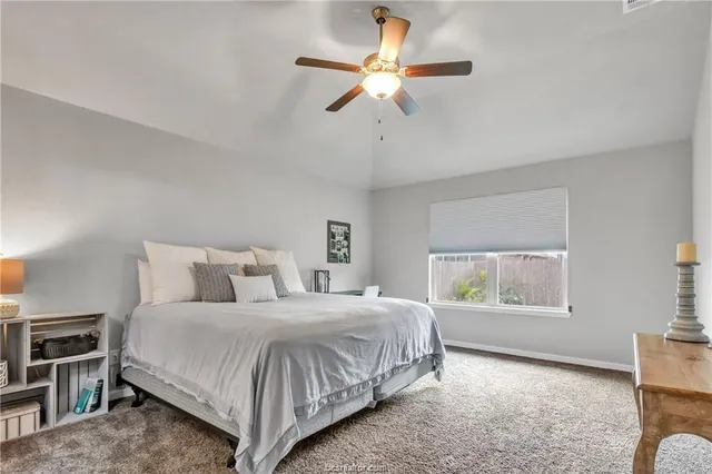 a bedroom with a bed and window