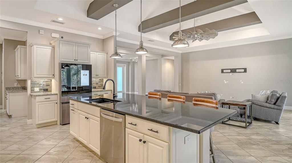 318 Ragdoll Run Bradenton, FL 34212 - Photo 18 of 87 a kitchen with stainless steel appliances granite countertop a sink and cabinets