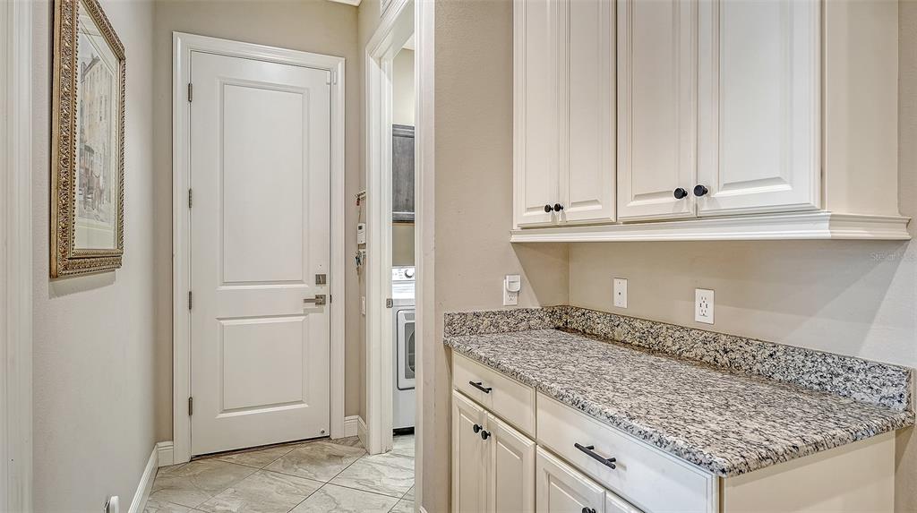 318 Ragdoll Run Bradenton, FL 34212 - Photo 23 of 87 a kitchen with granite countertop white cabinets and sink