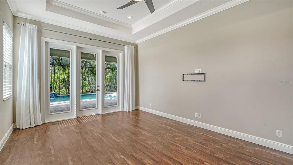 318 Ragdoll Run Bradenton, FL 34212 - Photo 26 of 87 an empty room with wooden floor and windows