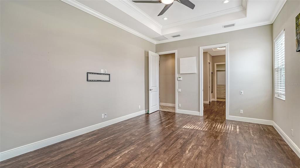 318 Ragdoll Run Bradenton, FL 34212 - Photo 27 of 87 an empty room with wooden floor and windows