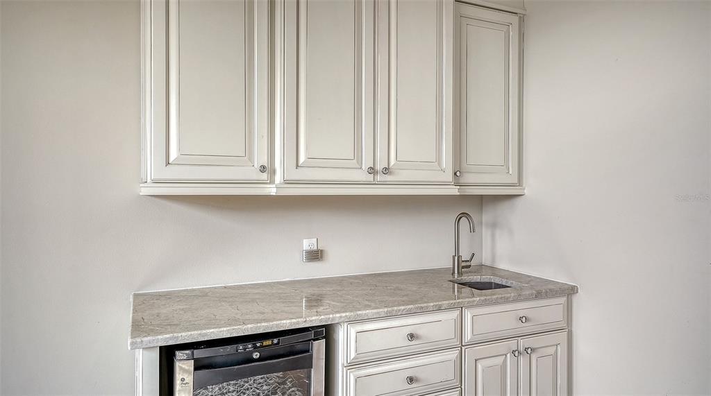318 Ragdoll Run Bradenton, FL 34212 - Photo 46 of 87 a kitchen with granite countertop white cabinets and a wooden floor