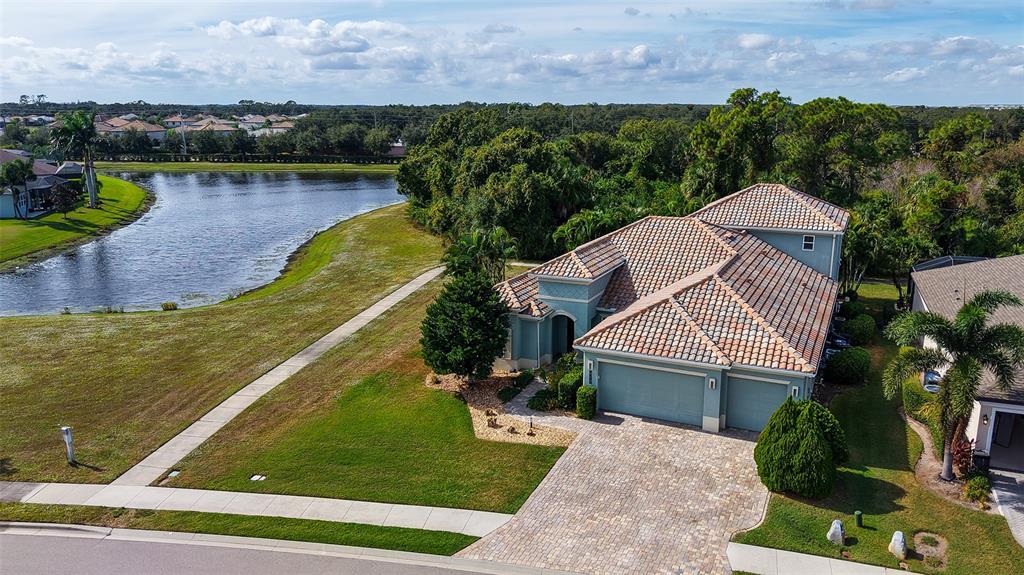 318 Ragdoll Run Bradenton, FL 34212 - Photo 59 of 87 an aerial view of a house with a garden and lake view