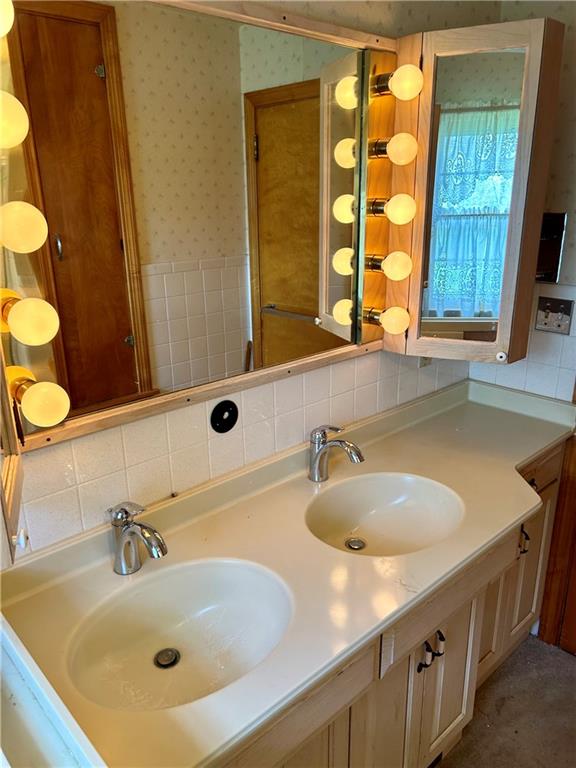 23 Paxton Road Sandy Lake, PA 16145 - Photo 24 of 25 a bathroom with a sink and a large mirror