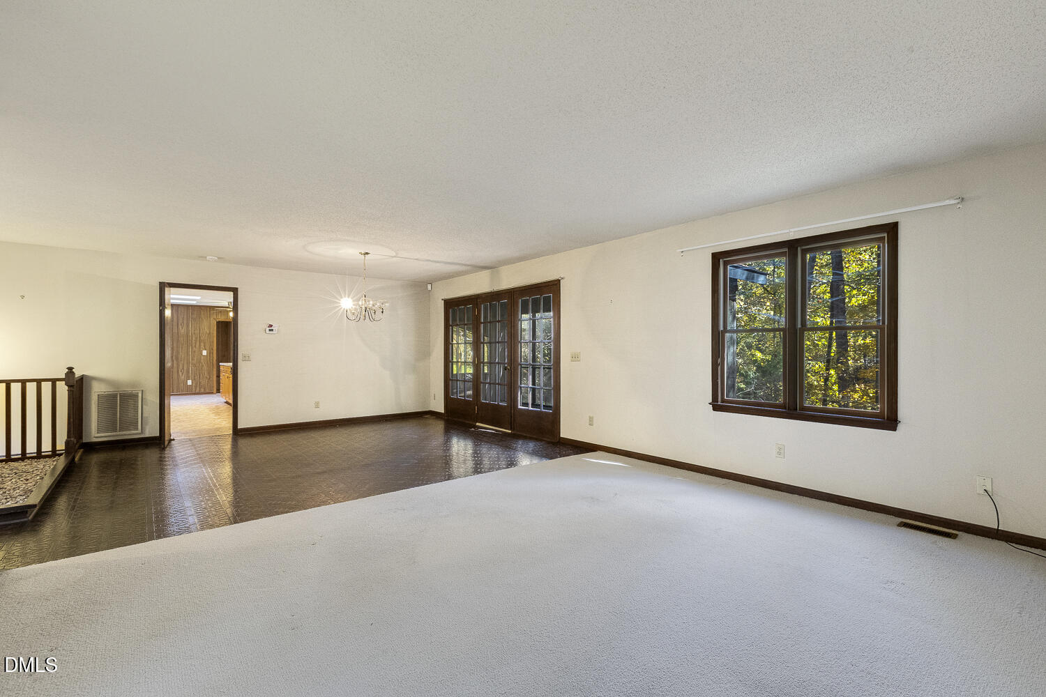 3028 Ethan Lane Raleigh, NC 27613 - Photo 10 of 58 a view of an empty room with window and wooden floor