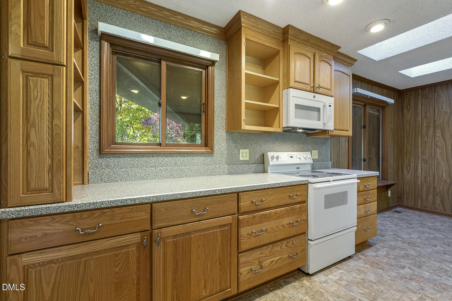3028 Ethan Lane Raleigh, NC 27613 - Photo 13 of 58 a kitchen with stainless steel appliances granite countertop a stove and a sink