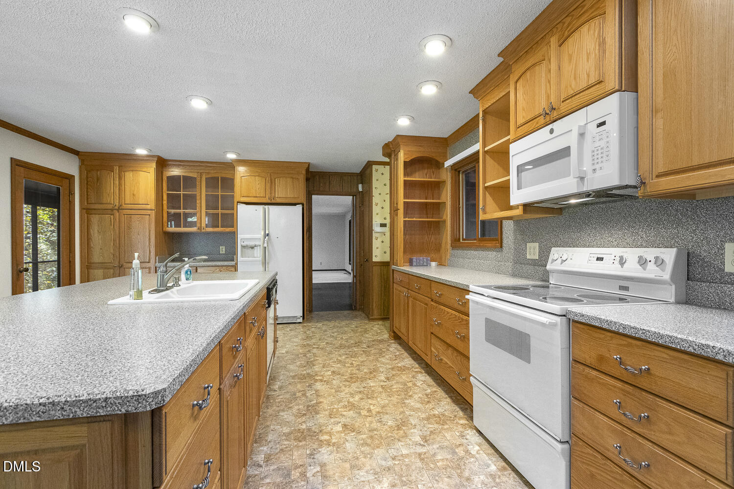 3028 Ethan Lane Raleigh, NC 27613 - Photo 14 of 58 a kitchen with stainless steel appliances granite countertop a sink and cabinets