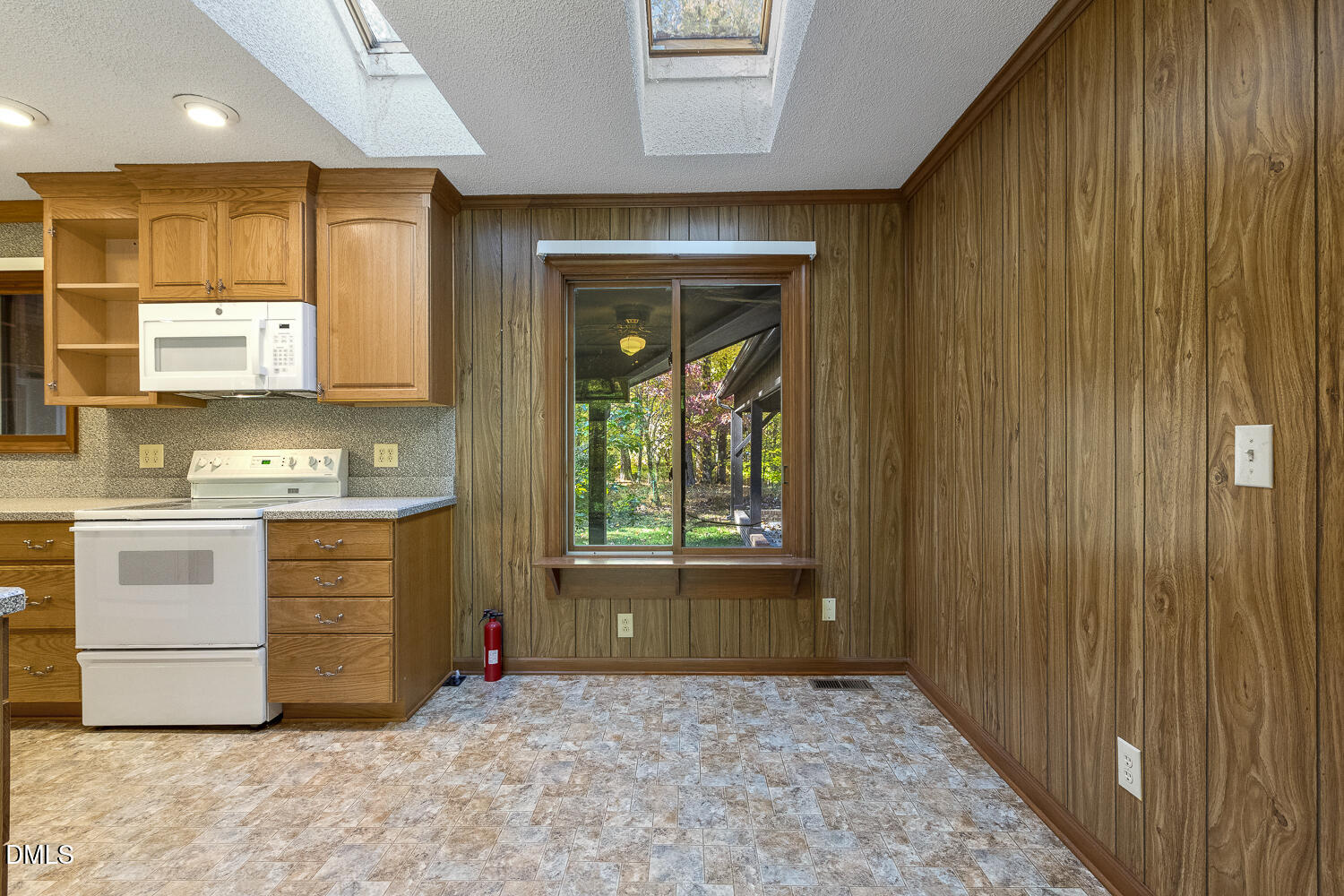 3028 Ethan Lane Raleigh, NC 27613 - Photo 17 of 58 a view of a kitchen with an entryway and a stove