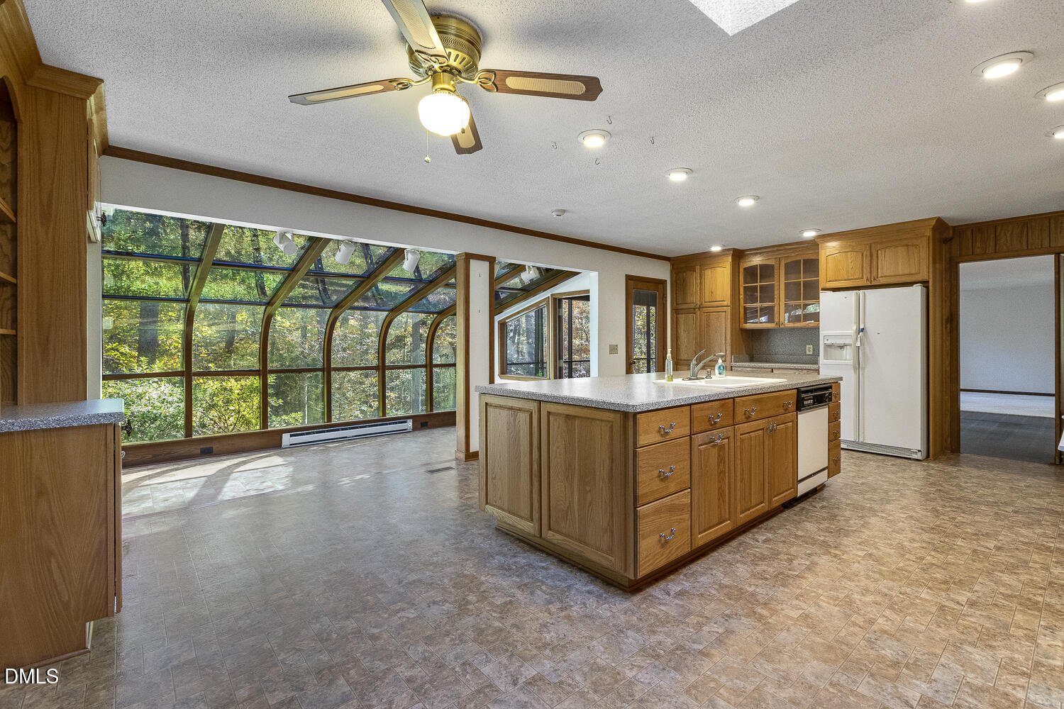 3028 Ethan Lane Raleigh, NC 27613 - Photo 18 of 58 a kitchen with stainless steel appliances granite countertop a refrigerator a oven a sink with wooden cabinets and glass door