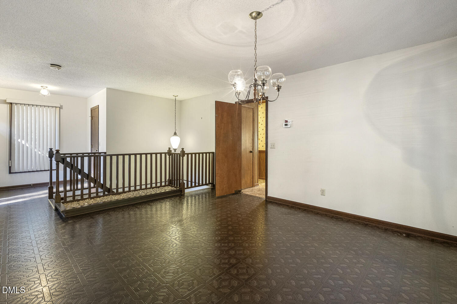 3028 Ethan Lane Raleigh, NC 27613 - Photo 9 of 58 a view of a room with wooden floor staircase and a ceiling fan