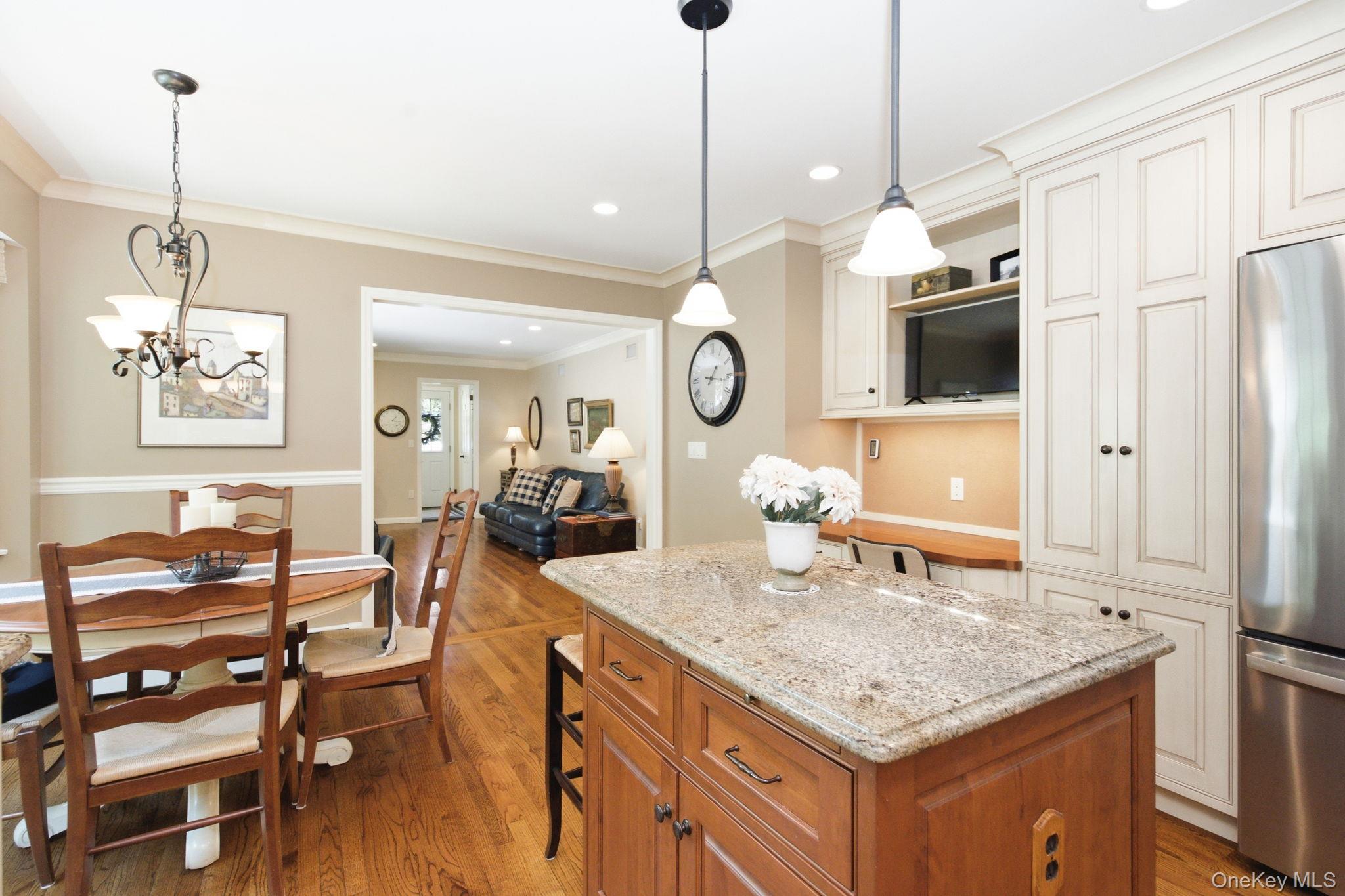 32 Bedell Road Katonah, NY 10536 - Photo 15 of 49 Pendant lighting and open sightlines connect the kitchen to the family room.