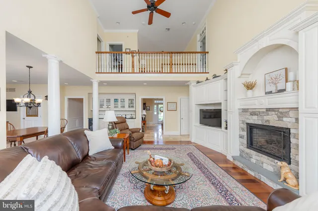 a living room with furniture and floor to ceiling windows