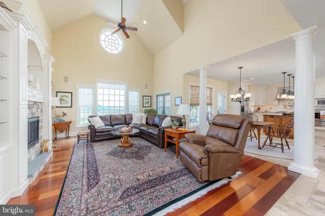 a view of a hallway with a dining table chairs