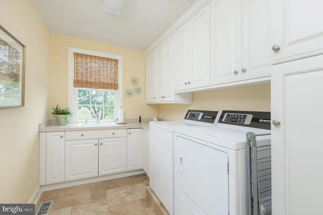 a view of a patio with chairs under an umbrella