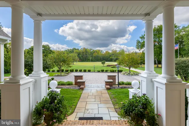 a view of a dining room with furniture a chandelier and wooden floor