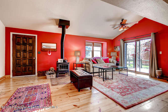 40 Riversedge Court, Unit A Basalt, CO 81621 - Photo 1 of 12 a living room filled with furniture and a wooden floor