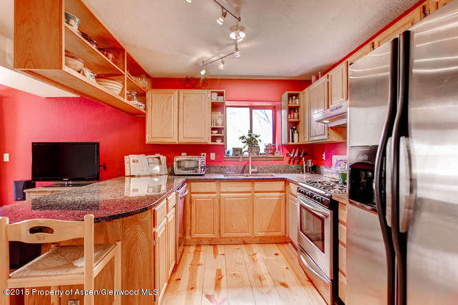 40 Riversedge Court, Unit A Basalt, CO 81621 - Photo 4 of 12 a kitchen with stainless steel appliances granite countertop a sink stove and refrigerator