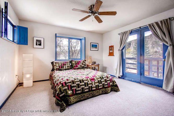 40 Riversedge Court, Unit A Basalt, CO 81621 - Photo 6 of 12 a bedroom with a large bed and a window