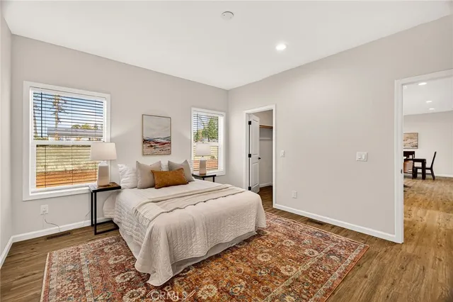 a bedroom with a bed and wooden floor