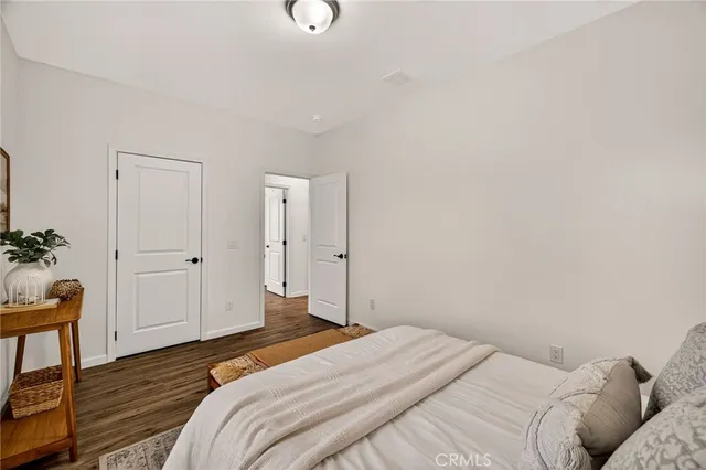 a bedroom with a bed and a potted plant