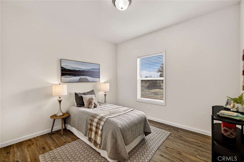 6160 Beacon Court Paradise, CA 95969 - Photo 25 of 34 a bedroom with a bed and wooden floor