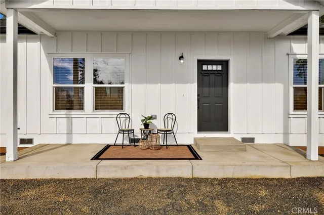 a living room with stainless steel appliances kitchen island granite countertop furniture and a rug