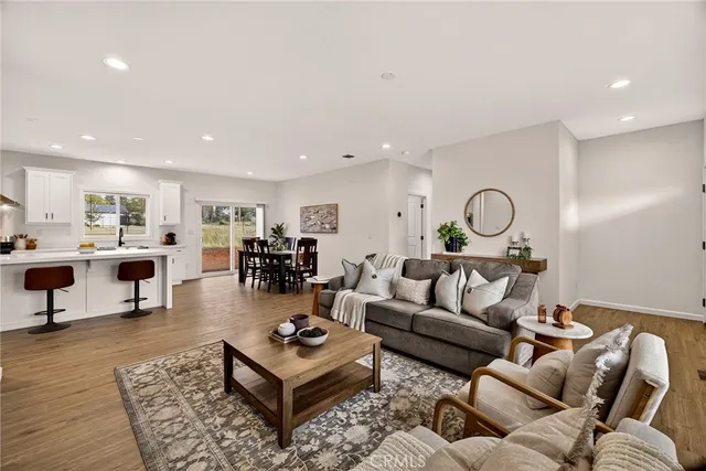 a living room with furniture kitchen view and a table