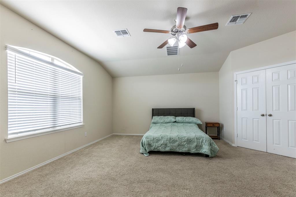 2904 Beutel Road Lorena, TX 76655 - Photo 14 of 40 a room with a bed and a chandelier
