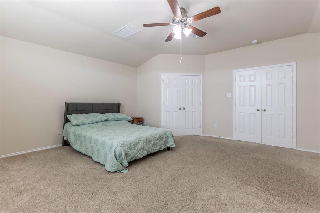 2904 Beutel Road Lorena, TX 76655 - Photo 15 of 40 a bedroom with a bed and a ceiling fan