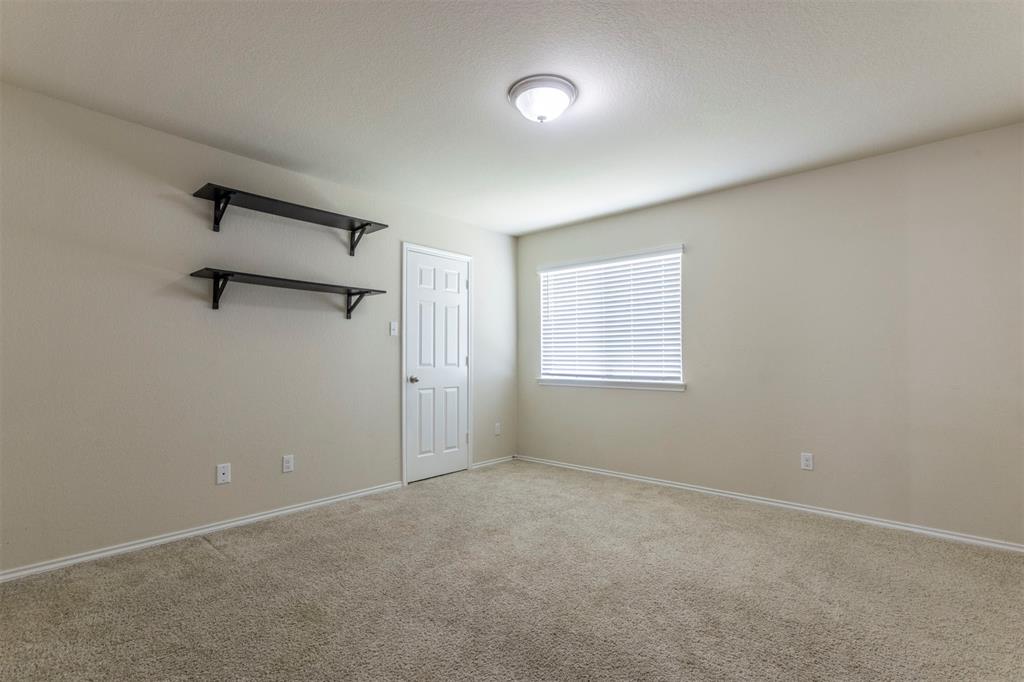 2904 Beutel Road Lorena, TX 76655 - Photo 27 of 40 an empty room with windows and a ceiling fan