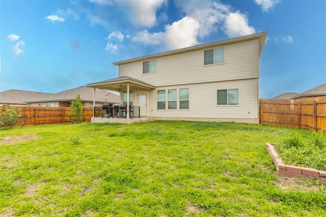 a view of a house with a backyard
