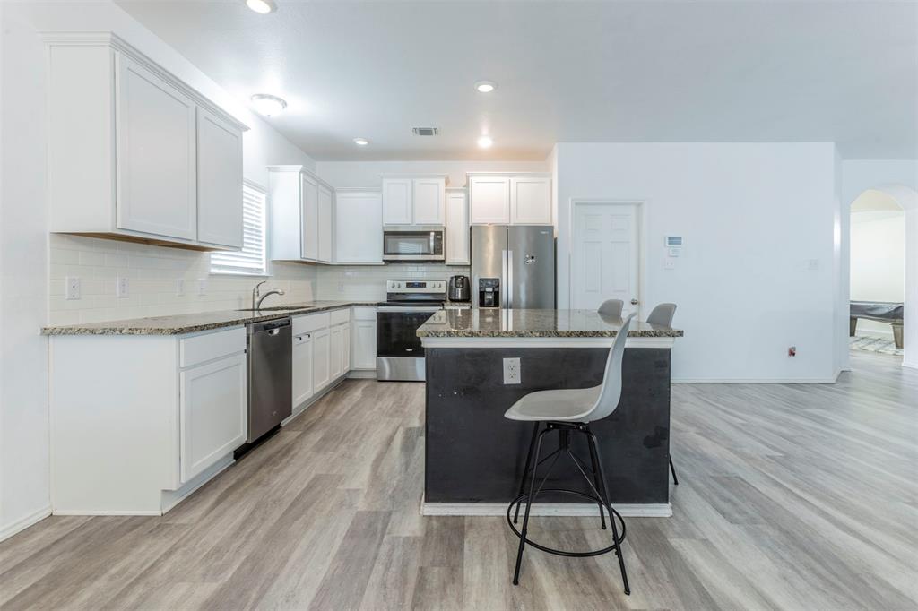 2904 Beutel Road Lorena, TX 76655 - Photo 6 of 40 a kitchen with stainless steel appliances granite countertop a stove a sink and a refrigerator
