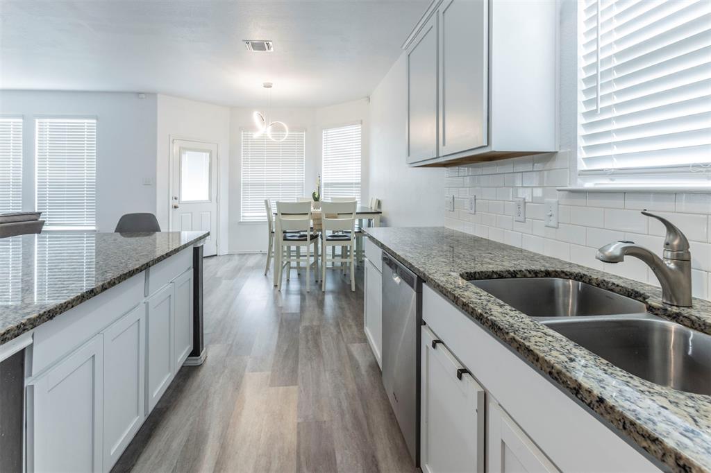 2904 Beutel Road Lorena, TX 76655 - Photo 8 of 40 a kitchen with sink cabinets and wooden floor