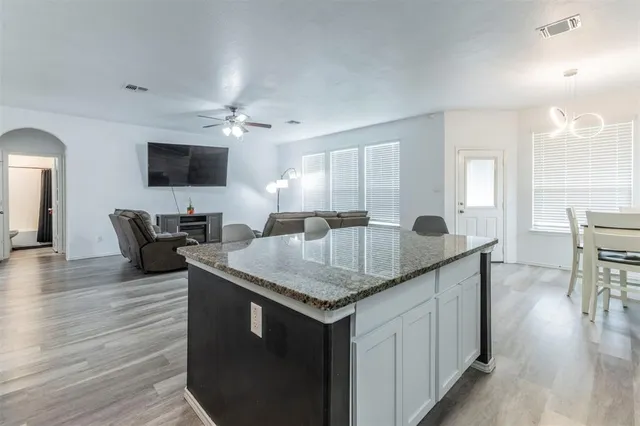 a kitchen with a stove a sink and a refrigerator