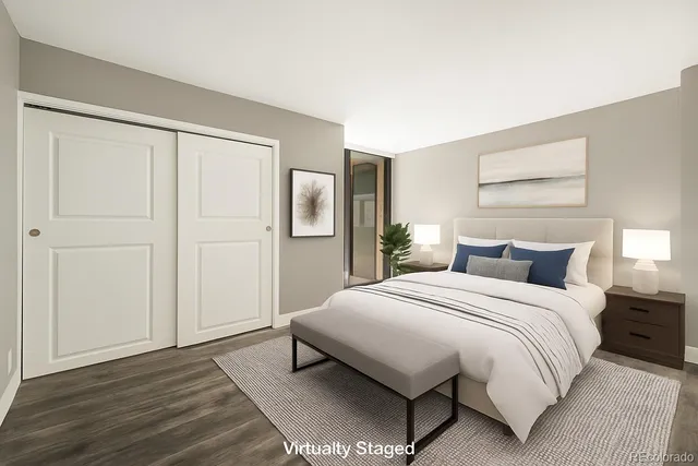 a bedroom with a bed and a painting